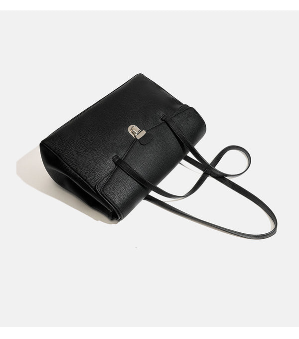 Structured black pebbled-finish flap tote bag with silver turn-lock clasp and long double shoulder straps, detail view 10