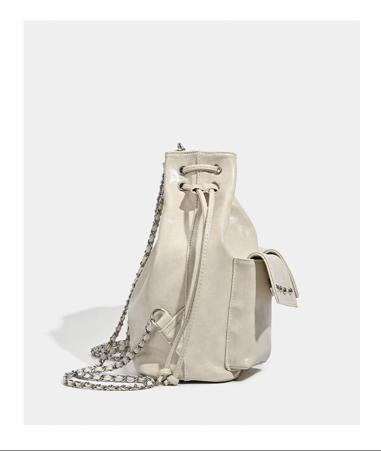 Glossy leather-look drawstring bucket bag with silver dome studs and chain shoulder strap, detail view 17