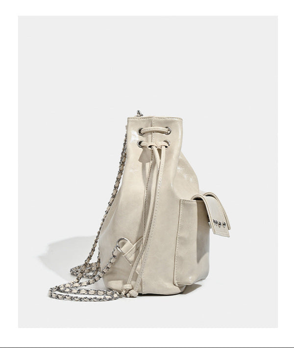 Glossy leather-look drawstring bucket bag with silver dome studs and chain shoulder strap, detail view 17