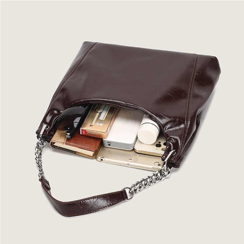 Glossy crinkled leather-look slouchy hobo bag with silver chain-and-leather shoulder strap and open top, detail view 4