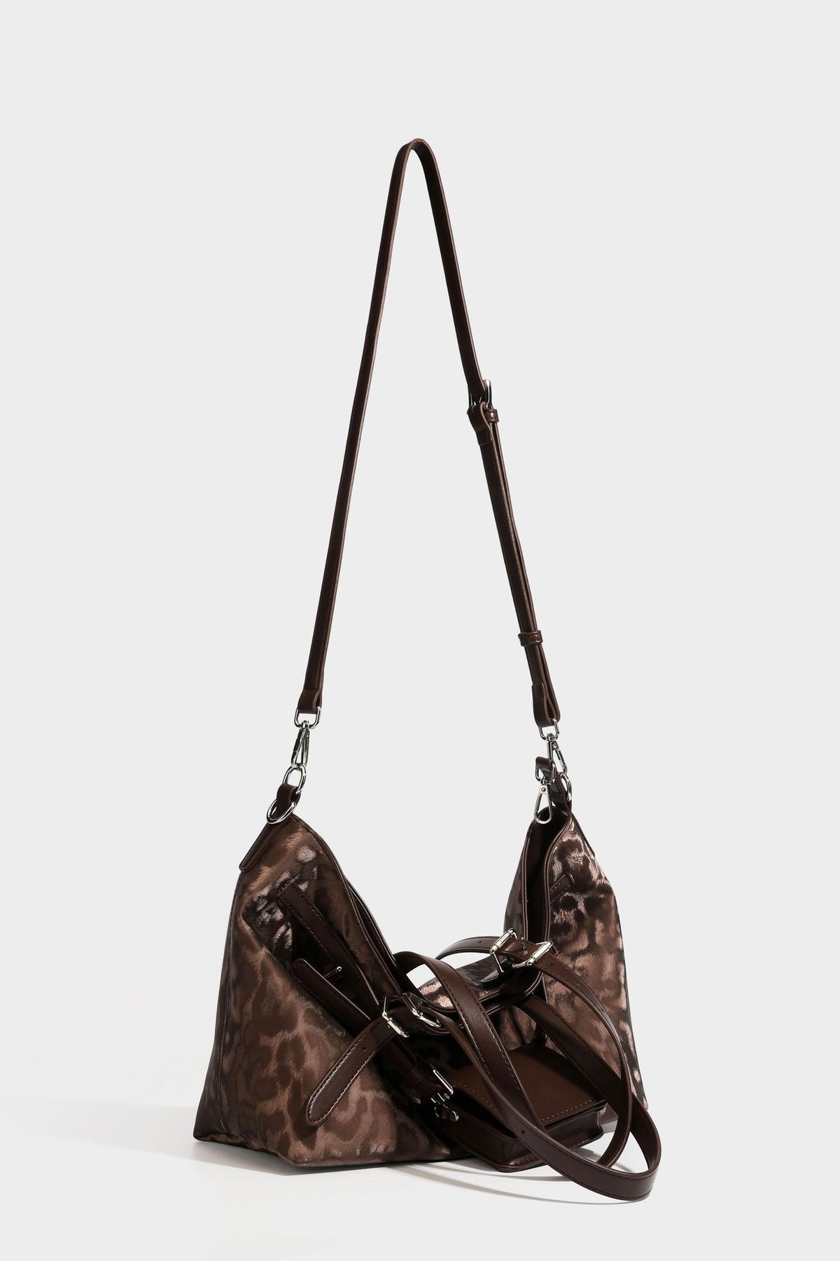 Glossy leopard-print tote bag with leather-look dark trim, dual top handles, detachable shoulder strap, and attached front