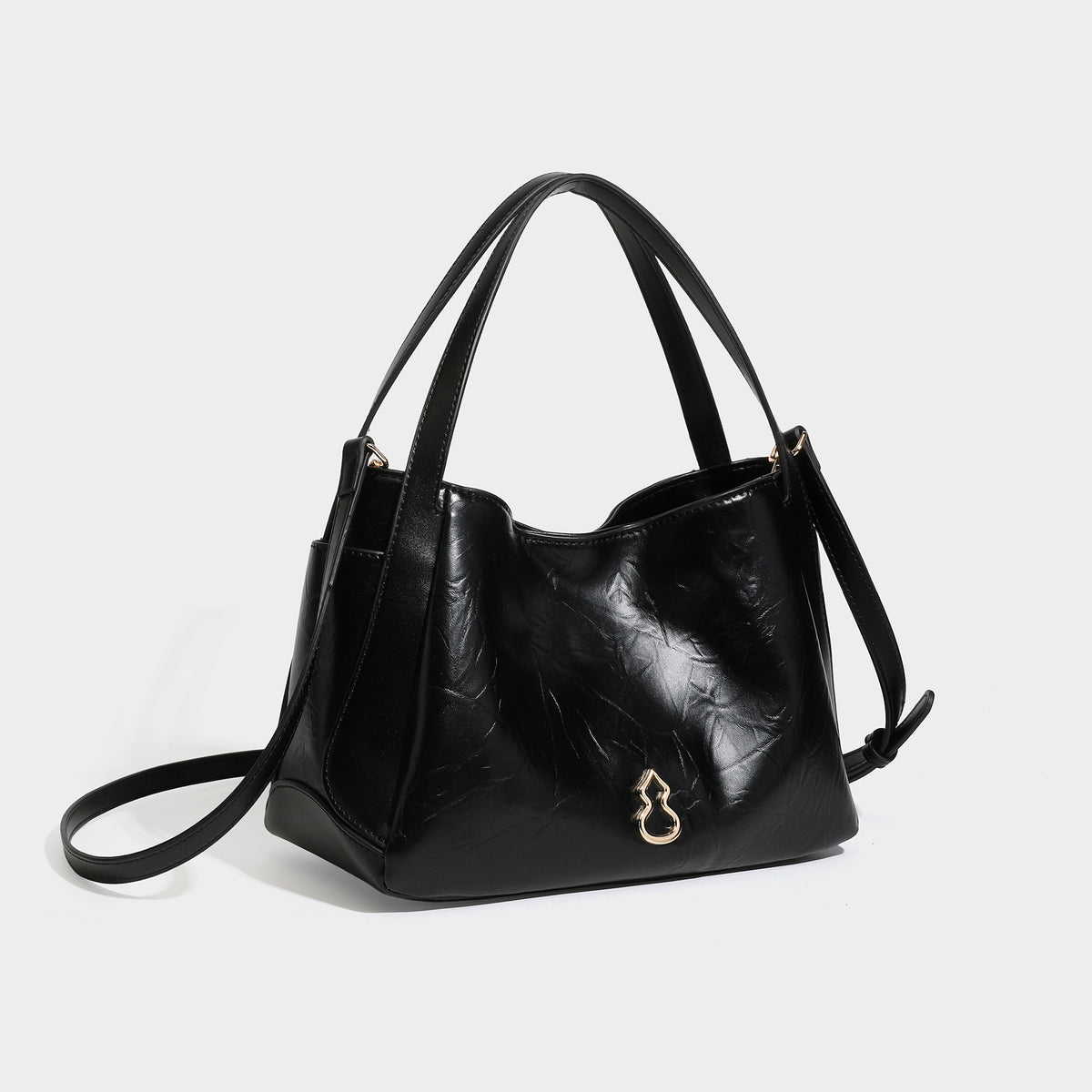 Black glossy crinkled leather-look convertible shoulder tote bag with gold gourd-shaped emblem hardware and detachable