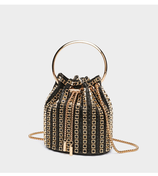 Mini crystal rhinestone bucket bag with circular ring top handle, drawstring closure, and silver chain shoulder strap, detail