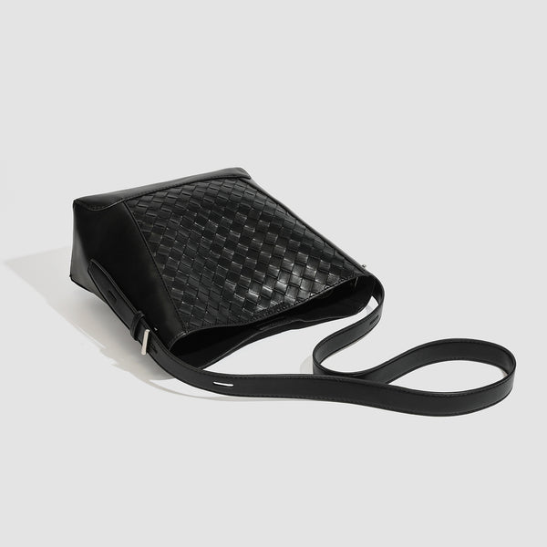 Large black bucket shoulder bag with diamond woven leather-look front panel, smooth side panels, magnetic snap closure, and