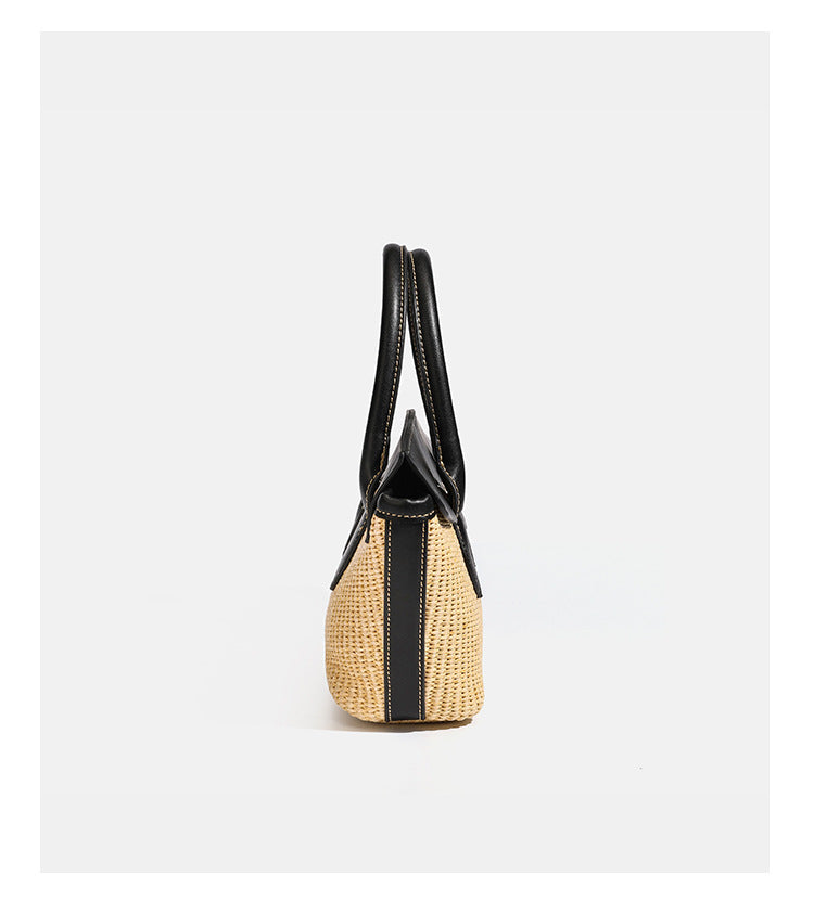 Structured tan woven straw tote bag with black leather-look trim, twin rounded top handles, gold-tone turn-lock front flap