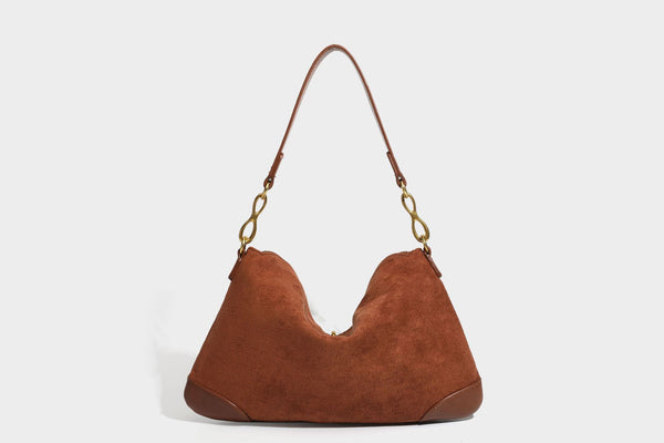 Slouchy denim shoulder bag with dark leather-look trim, gold-tone chain-link hardware, and top zipper closure, detail view 24