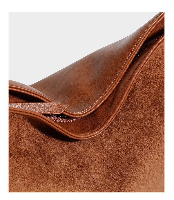 Slouchy suede-finish brown shoulder bag with long single strap and small gold-tone logo emblem on front, detail view 22