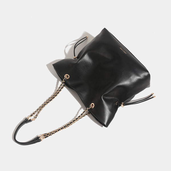 Soft-structured leather-look tote bag with gold-tone chain-and-strap shoulder handles and side drawstring cinches, detail