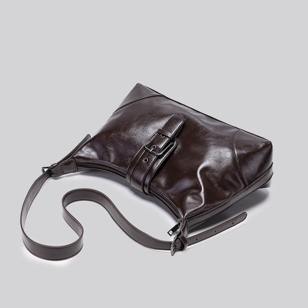 Glossy dark brown slouch hobo shoulder bag with front buckle strap panel and long adjustable single strap, detail view 4