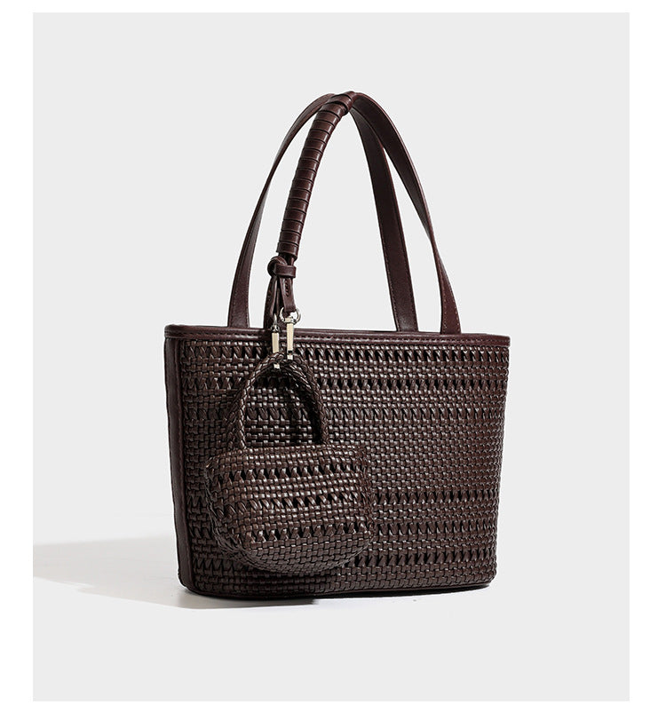 Structured open-weave tote bag with smooth leather-look trim, double top handles, detachable crossbody strap, and mini zip