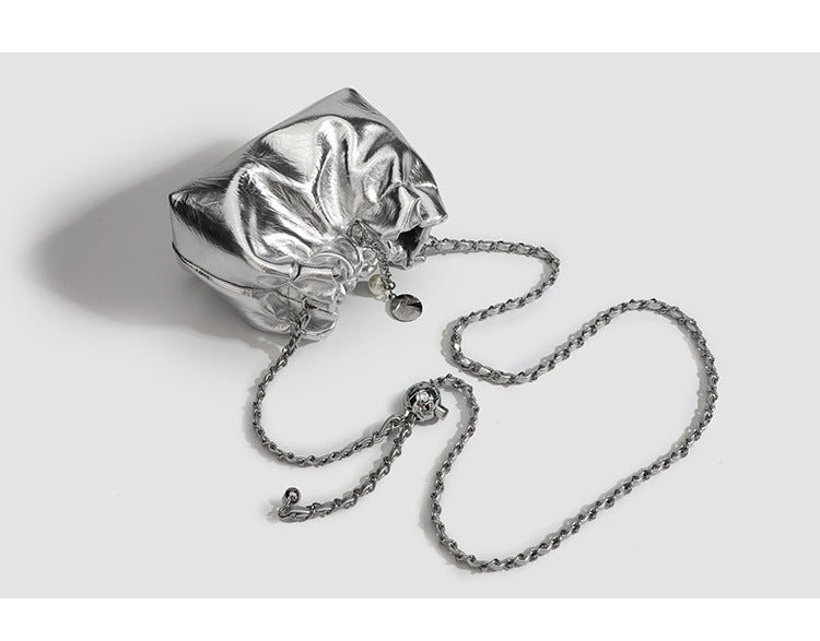 Small ruched drawstring bucket bag with twisted-link chain strap and pearl charm pull, detail view 9