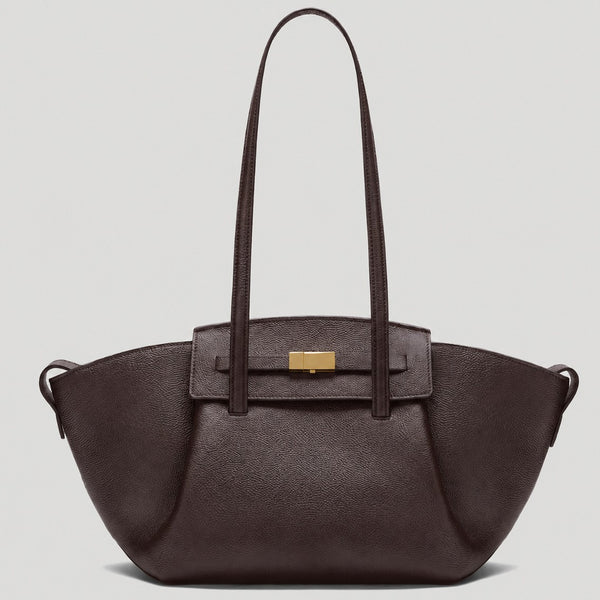 Black pebbled trapezoid tote bag with gold turn-lock hardware and double top handles, front view