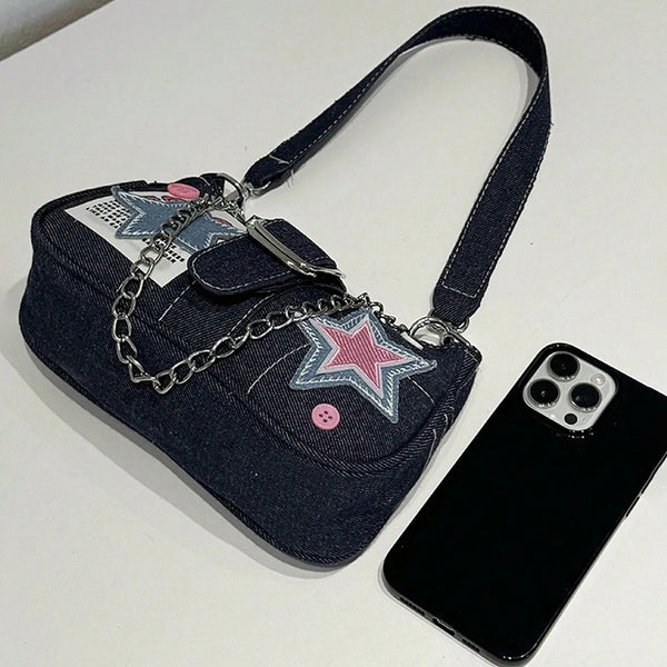 Dark navy denim-look shoulder bag with light blue and pink star appliqués, silver-tone buckle, chain strap, and short top
