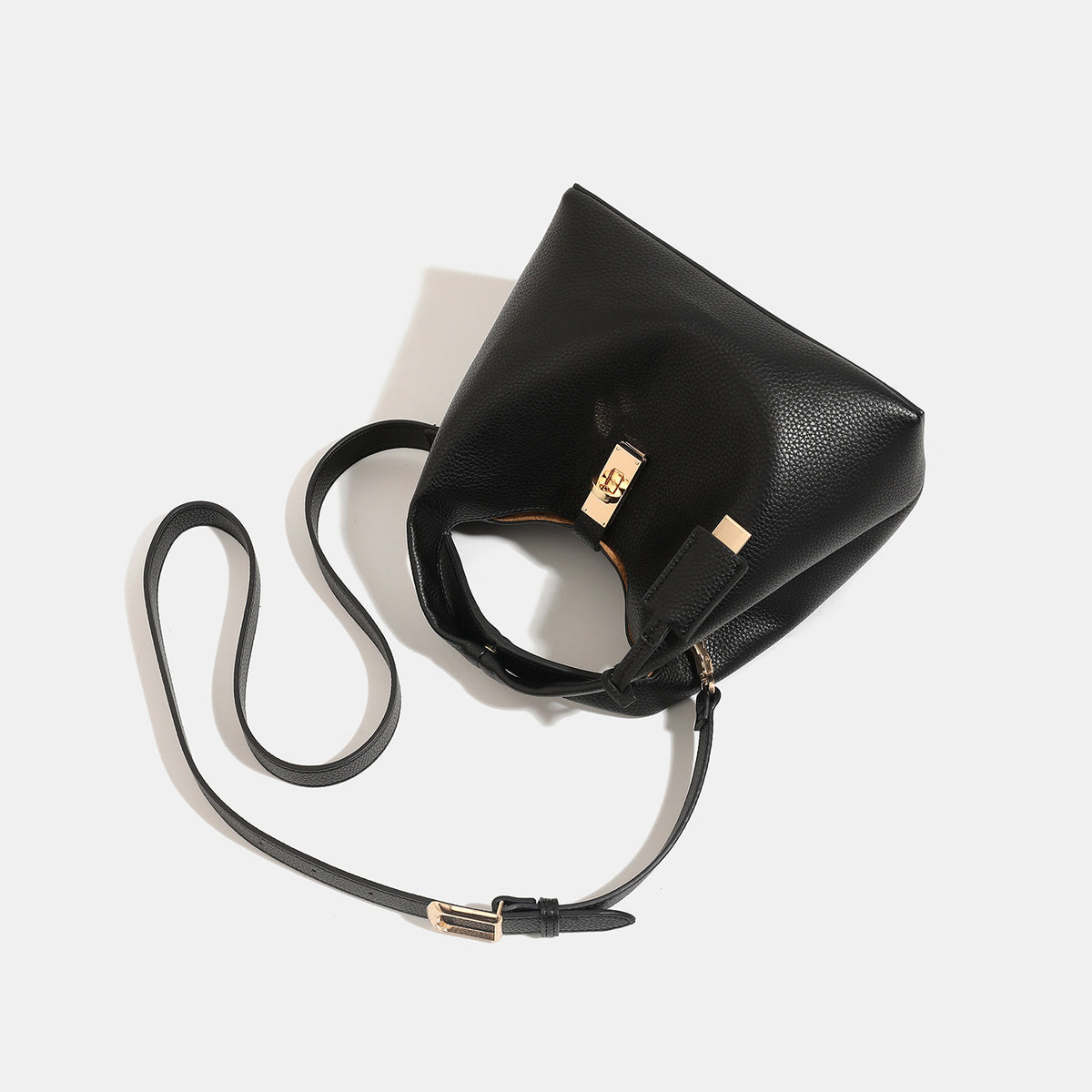 Structured pebbled leather-look bucket bag with gold-tone turn-lock clasp and looped top handle, detail view 4