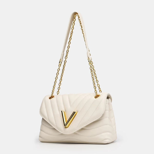 Small structured diamond-quilted flap shoulder bag with gold-tone V-shaped hardware and chain strap, detail view 3