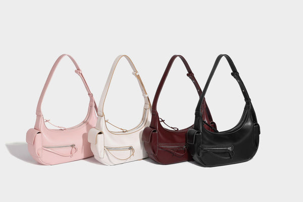 Smooth leather-look crescent shoulder bag with front zip pocket, side flap pockets, adjustable strap, and silver-tone, detail