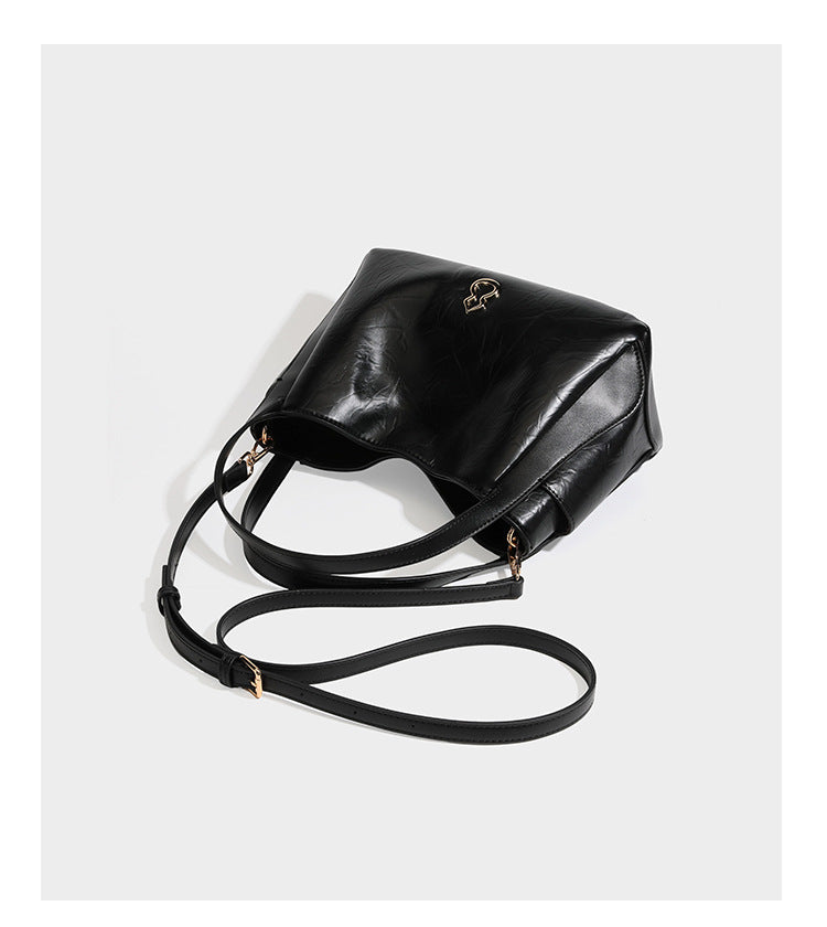 Black glossy crinkled leather-look convertible shoulder tote bag with gold gourd-shaped emblem hardware and detachable