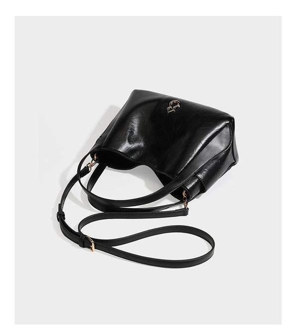 Black glossy crinkled leather-look convertible shoulder tote bag with gold gourd-shaped emblem hardware and detachable