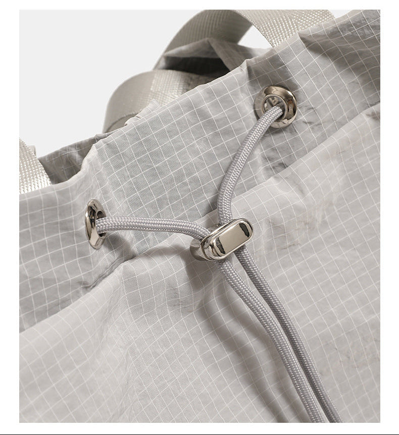 Glacier gray grid-texture nylon drawstring bucket convertible backpack with top handles and adjustable shoulder straps