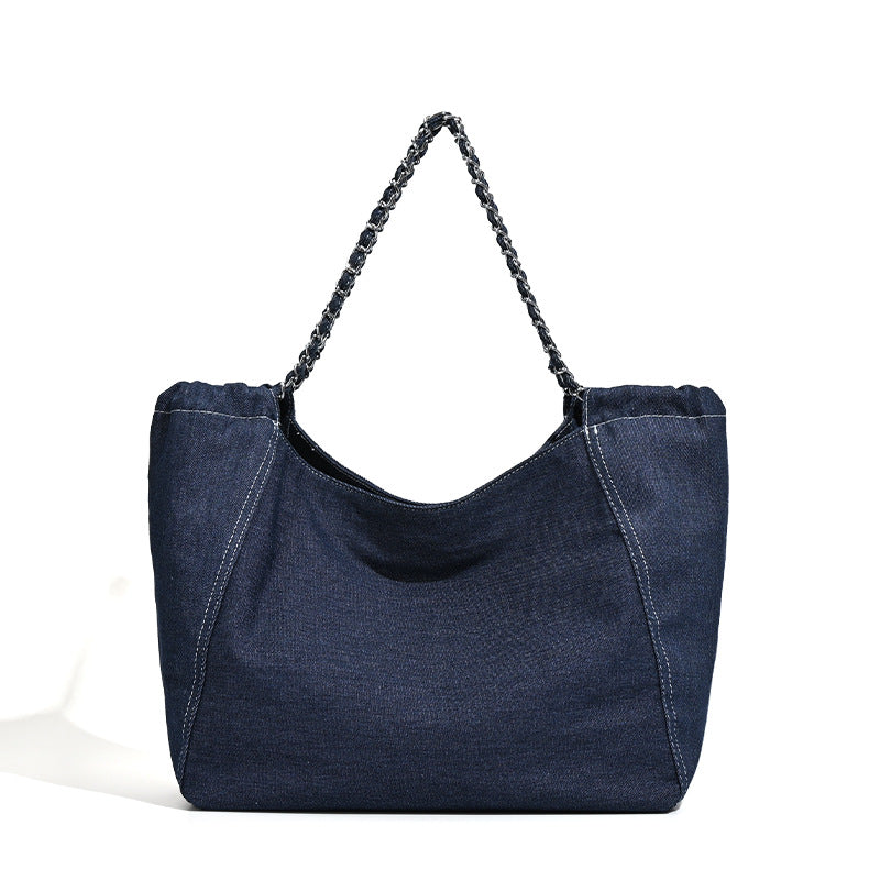 Large slouchy denim tote bag with silver-tone chain strap and contrast topstitching, detail view 5