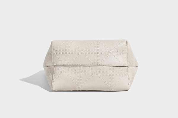 Quilted diamond-pattern tote bag with attached front zip pouch and long shoulder straps, detail view 25