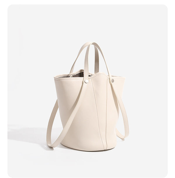 Large leather-look bucket tote bag with dual top handles and adjustable crossbody strap, detail view 10