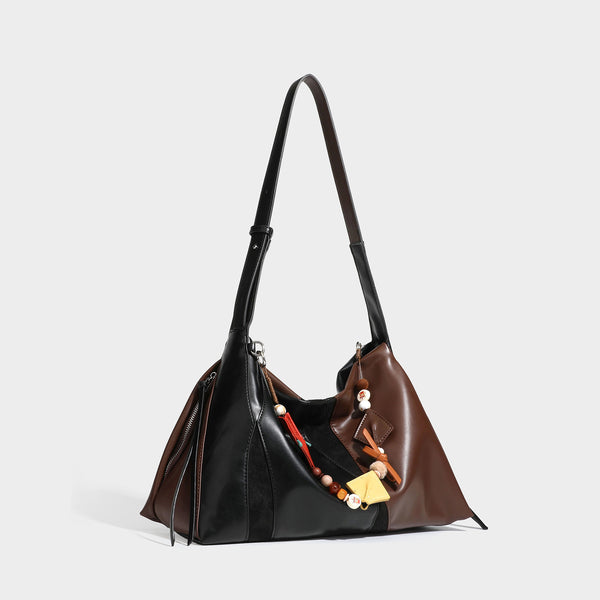 Two-tone black and brown leather-look slouchy shoulder bag with beaded tassel charm and silver-tone hardware, detail view 3