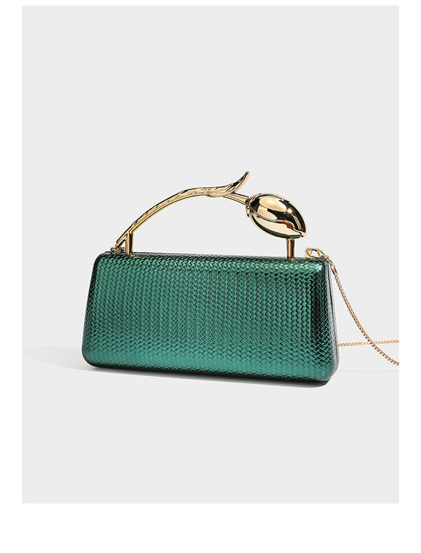 Structured rectangular metallic woven clutch bag with sculptural gold-tone leaf top handle and detachable chain strap, detail