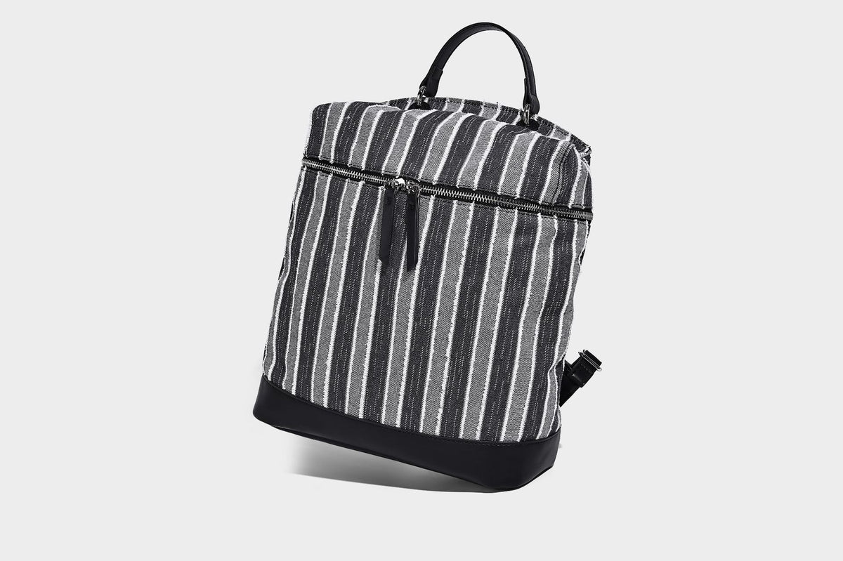 Small structured striped fabric backpack handbag with cream leather-look trim, top handle, and silver-tone hardware, detail