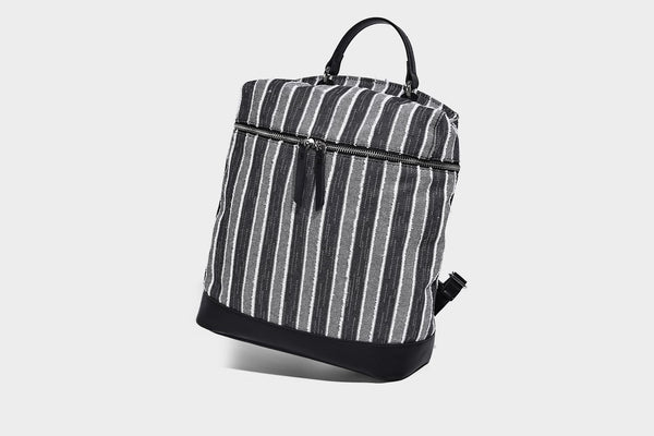 Small structured striped fabric backpack handbag with cream leather-look trim, top handle, and silver-tone hardware, detail