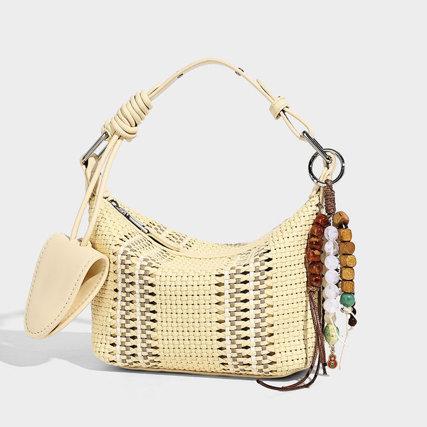 Small woven crescent shoulder bag with leather-look trim, zip closure, silver-tone ring hardware, and beaded tassel charm
