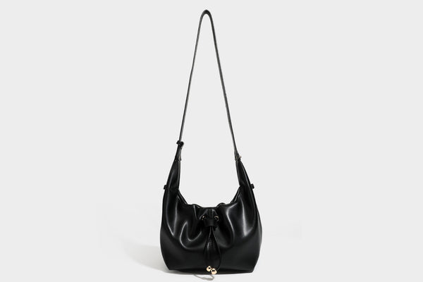 Slouchy hobo bag with smooth leather-look finish, drawstring cinch closure, and gold-tone bead hardware, detail view 35