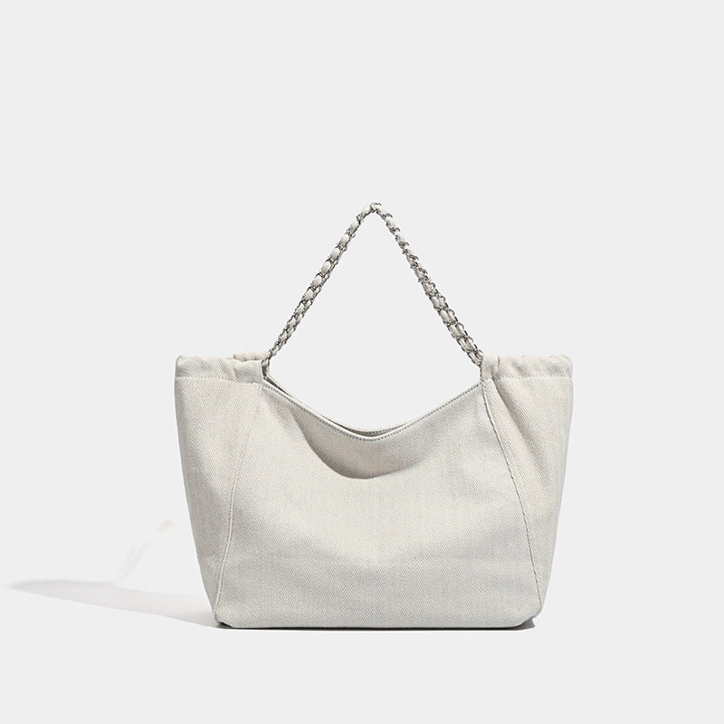 Large slouchy denim tote bag with silver-tone chain strap and contrast topstitching, detail view 8