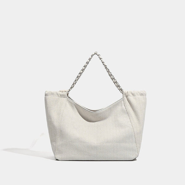 Large slouchy denim tote bag with silver-tone chain strap and contrast topstitching, detail view 8