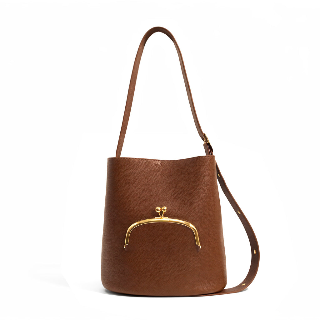 Pebbled textured bucket bag with gold-tone kiss-lock front pocket and adjustable single shoulder strap, detail view 8