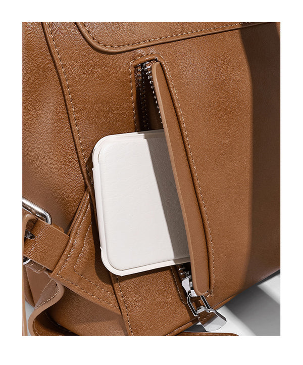 Structured tan leather-look flap backpack handbag with top handle, silver buckle hardware, and fold-over front closure