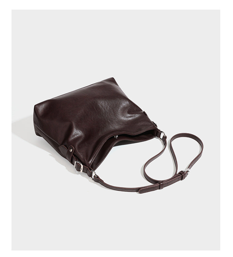 Large slouchy hobo shoulder bag in dark brown with smooth leather-look finish, adjustable strap, and silver-tone hardware