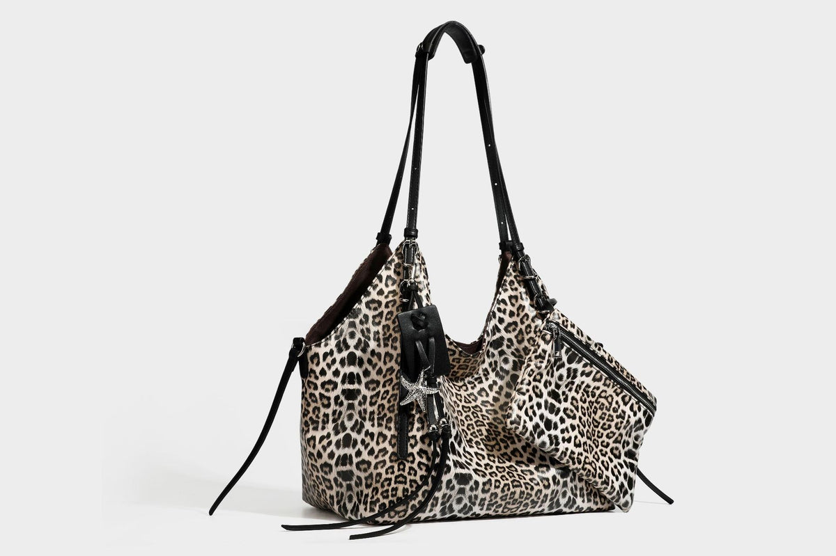 Large leopard print shoulder tote bag with glossy finish, long double straps, front zip pocket, silver-tone hardware, and