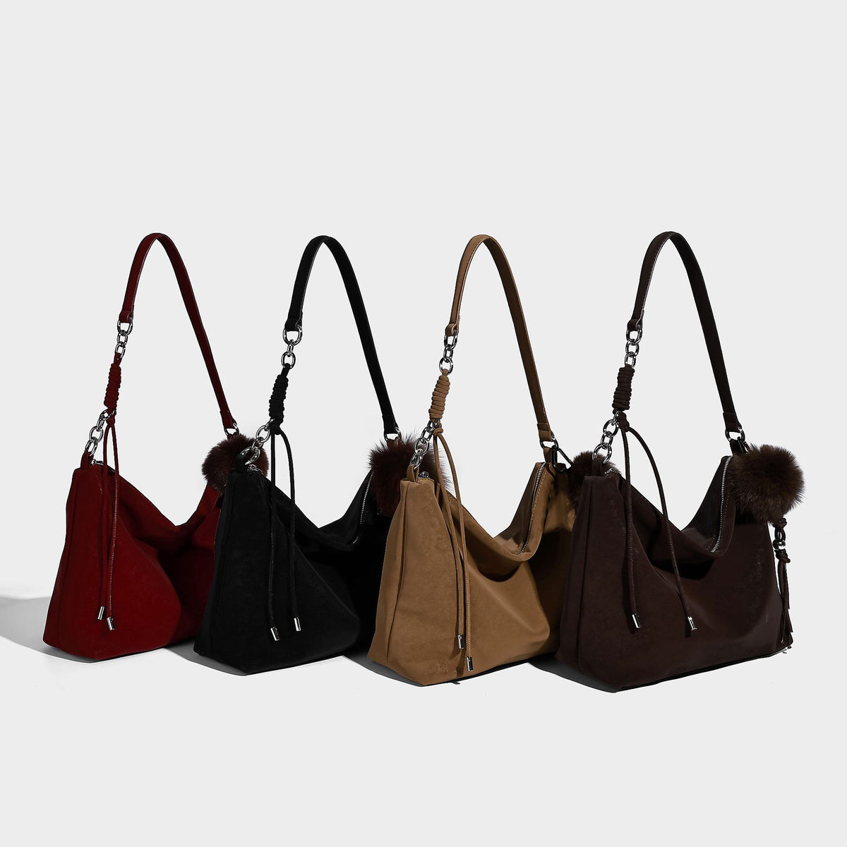 Slouchy matte-finish hobo shoulder bag with tassel cords, silver-tone hardware, and faux-fur pom charm, detail view 2