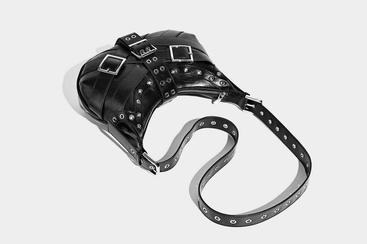 Glossy crescent hobo bag with silver-tone grommets, square buckle straps, and top zipper closure, detail view 24