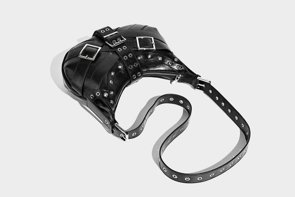 Glossy crescent hobo bag with silver-tone grommets, square buckle straps, and top zipper closure, detail view 24