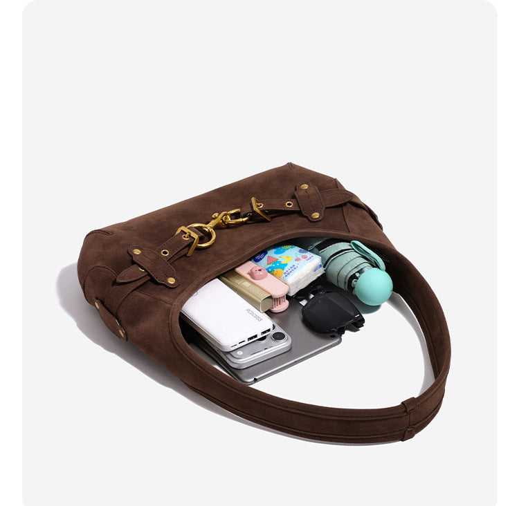 Slouchy hobo shoulder bag with gold-tone ring-and-buckle front hardware, zip top closure, and matte textured finish, detail