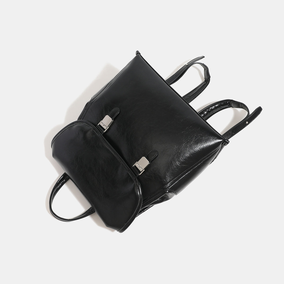 Structured glossy leather-look flap backpack with twin buckle closures and top grab handle, detail view 4