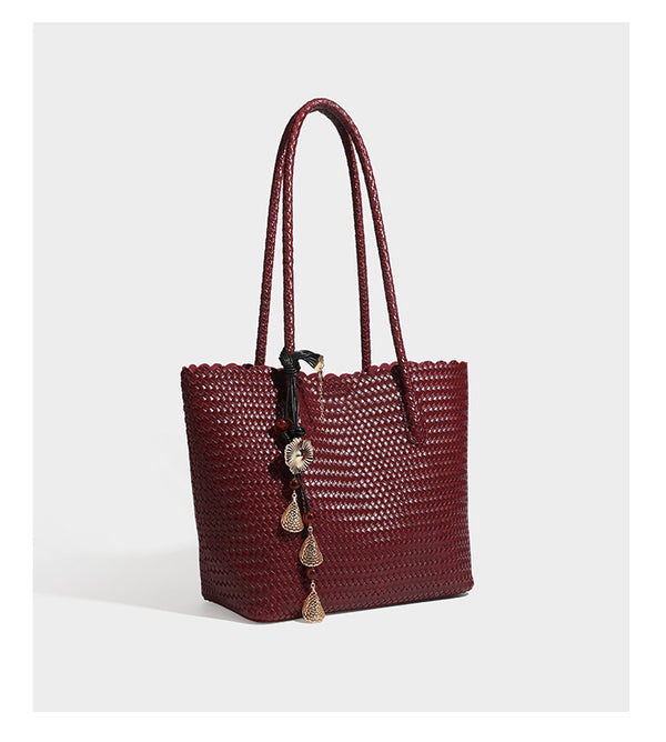 Large open-top woven leather-look tote bag in dark brown with scalloped edge, braided double shoulder straps, and decorative