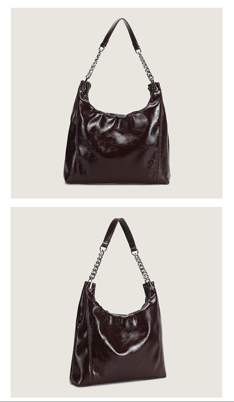 Glossy crinkled leather-look slouchy hobo bag with silver chain-and-leather shoulder strap and open top, detail view 9