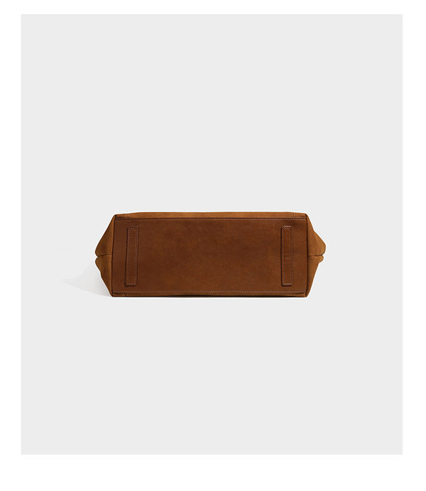 Oversized suede-finish tote shoulder bag in caramel brown with slim leather-look straps and gold-tone logo hardware, detail