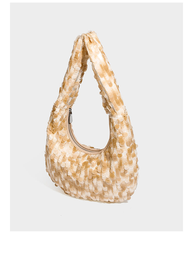 Slouchy crescent hobo shoulder bag covered in overlapping reflective sequin discs with a single integrated strap and top-zip