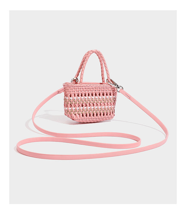 Large structured woven tote bag with striped basket-weave finish, long shoulder straps, and detachable mini pouch charm