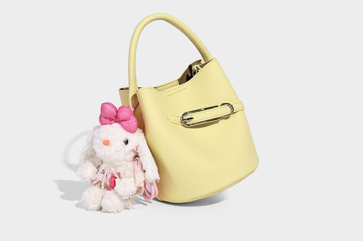 Mini pebbled leather-look bucket bag with front buckle strap, silver-tone hardware, top handle, and detachable shoulder