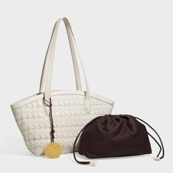 Large leather-look tote bag with geometric woven emboss, double shoulder straps, and round woven cord charm in brown, detail